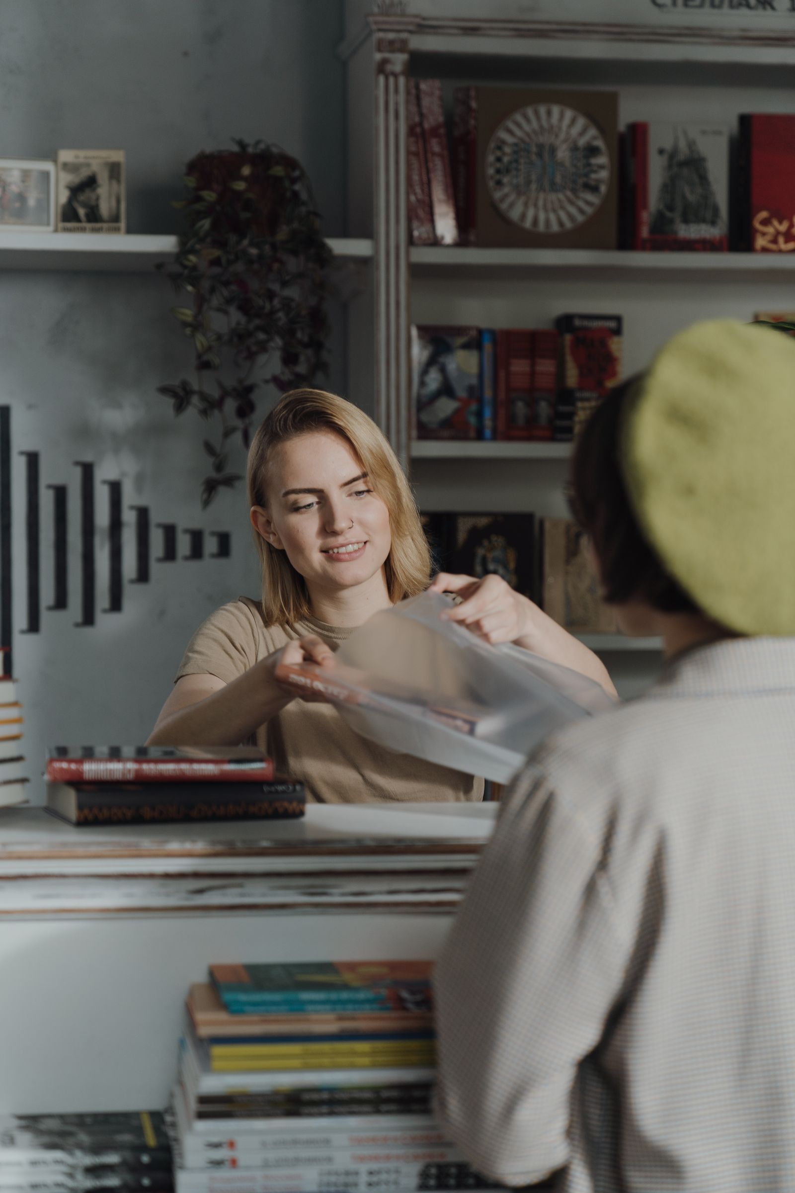 A bookseller helping a customer at the counter